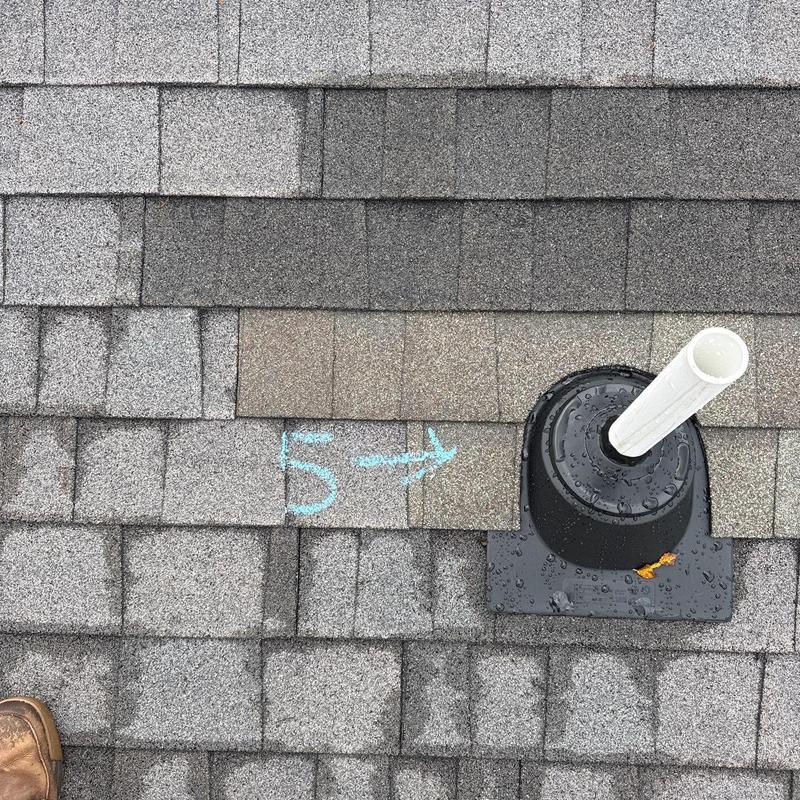 Asphalt shingles with ventilation pipe and chalk mark