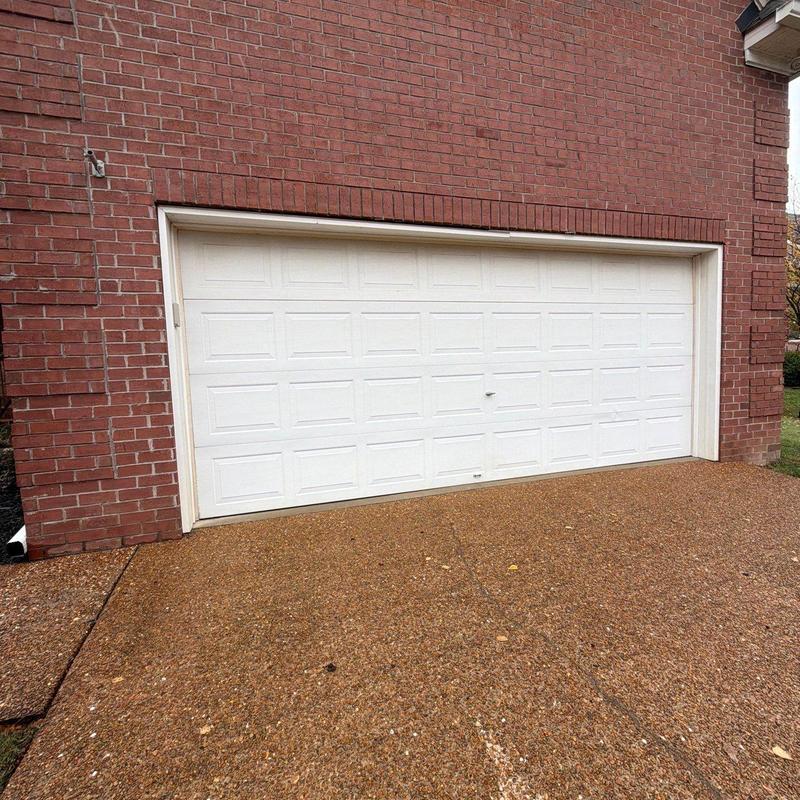 Garage door with bent frame and dented panels