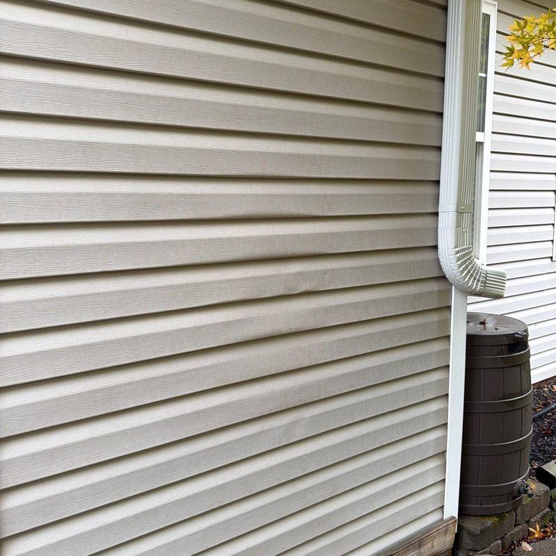 Vinyl siding with visible warping and dents