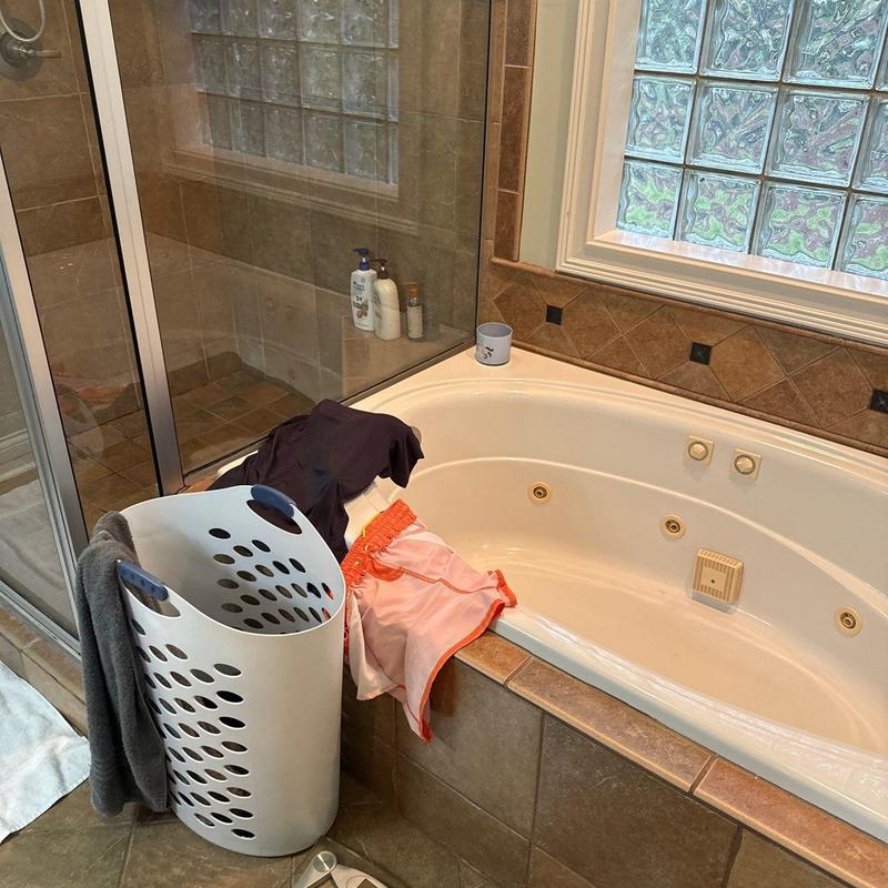 Jacuzzi tub with laundry basket and clothes
