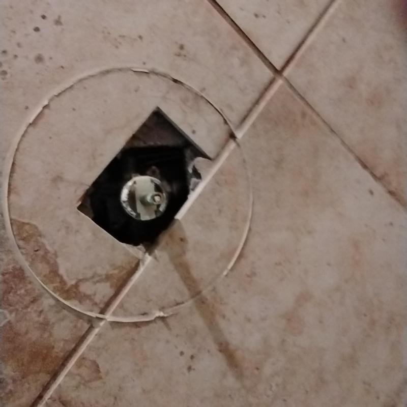 Moen shower valve cartridge behind tile floor panel
