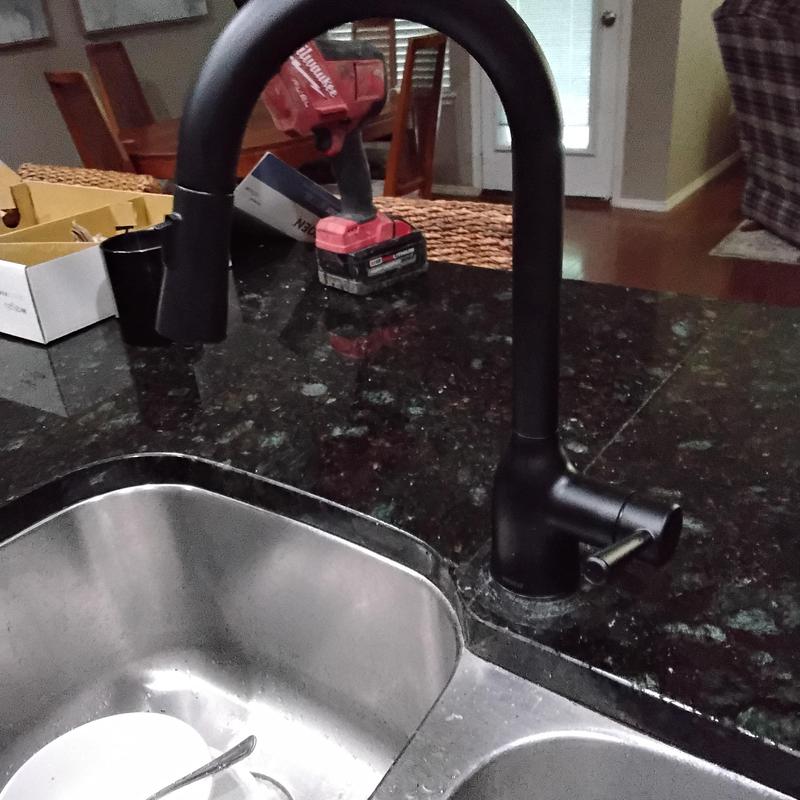 Kitchen sink black faucet installation on granite countertop