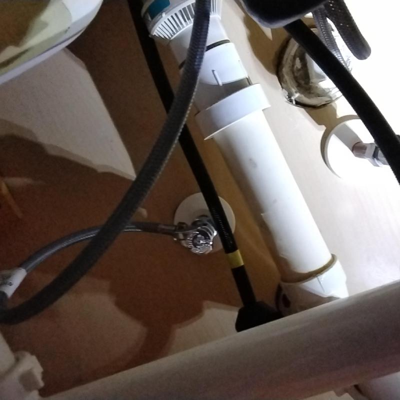 Kitchen faucet supply lines and white drain piping installation
