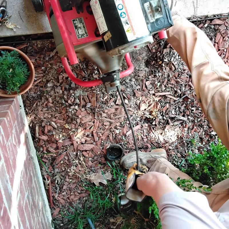 Mainline sewer drain cleaning machine in yard