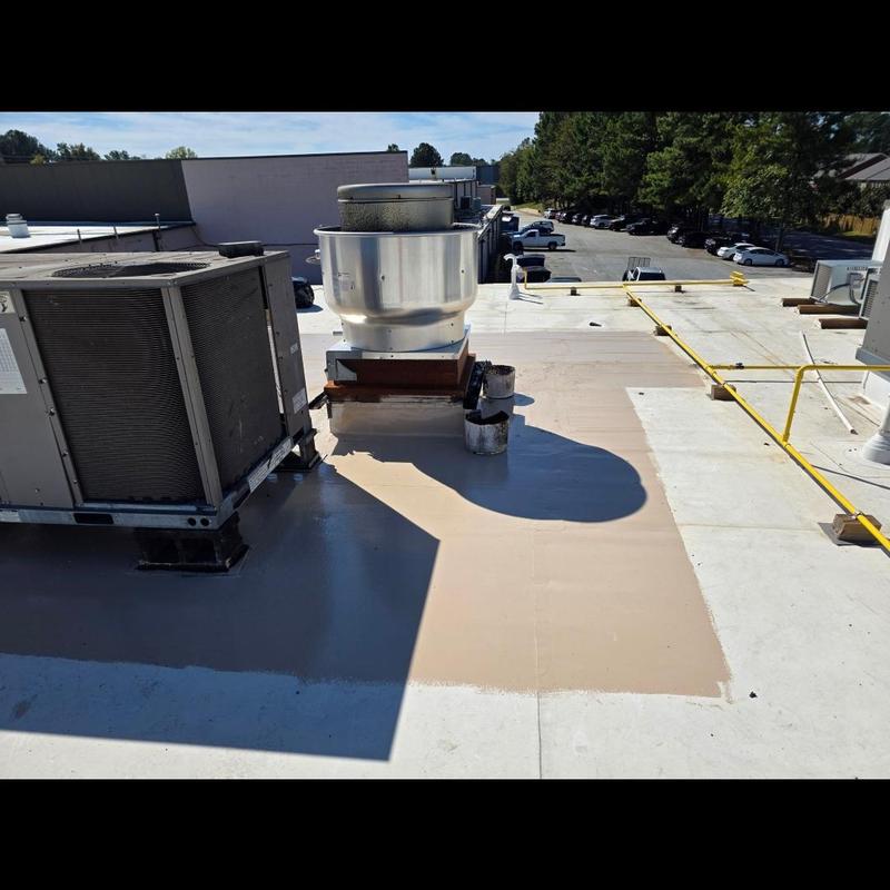 Silicone roof coating applied near rooftop HVAC units Silicone roof coating applied near rooftop HVAC units