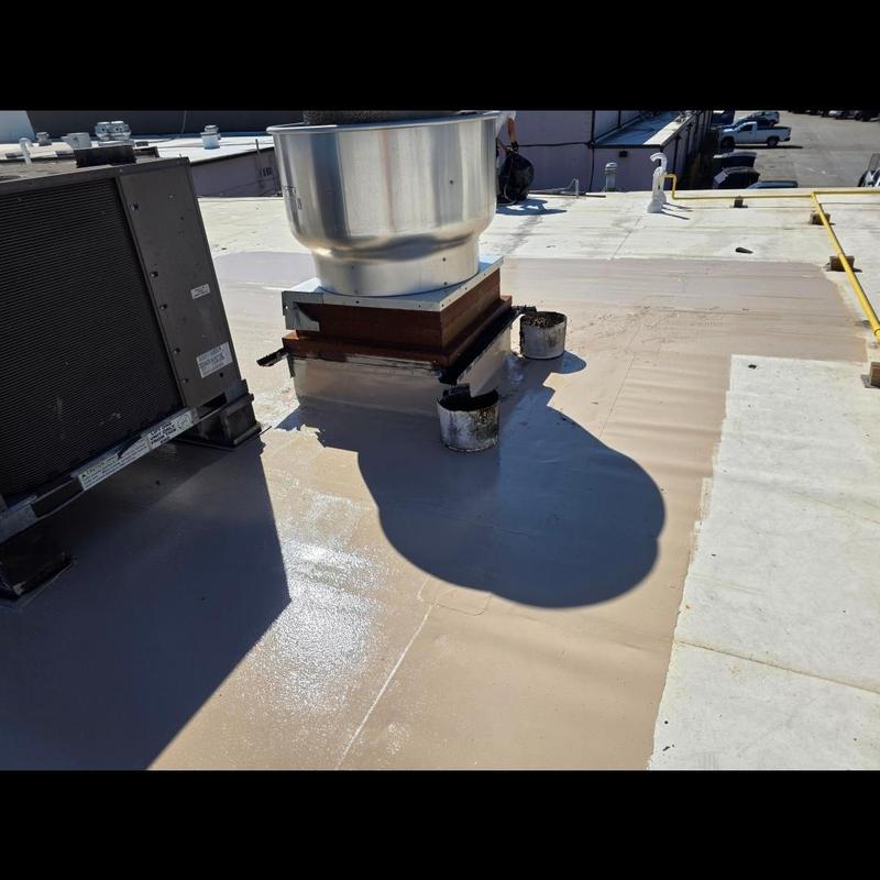 Silicone coating on commercial roof around vents and HVAC unit Silicone coating on commercial roof around vents and HVAC unit