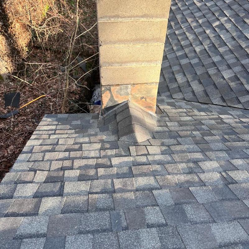 Roof shingles and chimney flashing installation on new roof Roof shingles and chimney flashing installation on new roof