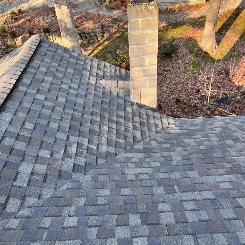 Asphalt shingle roof installation with chimney flashing Asphalt shingle roof installation with chimney flashing