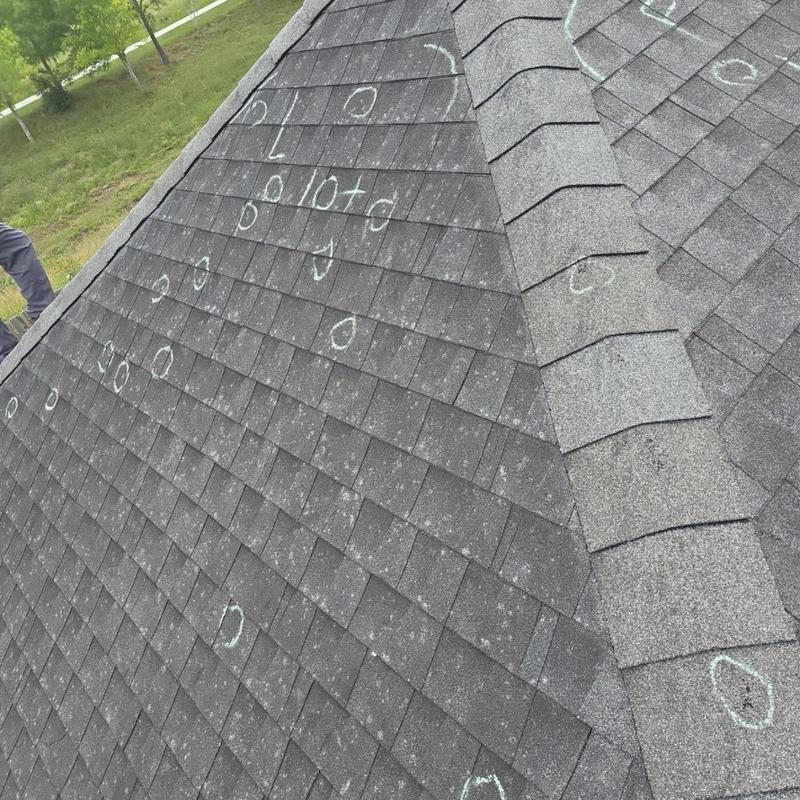 Asphalt roof shingles marked for hail damage inspection Asphalt roof shingles marked for hail damage inspection