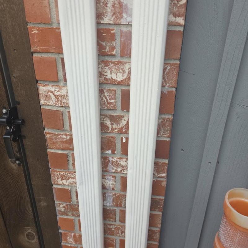 Downspouts with minor damage against brick wall Downspouts with minor damage against brick wall