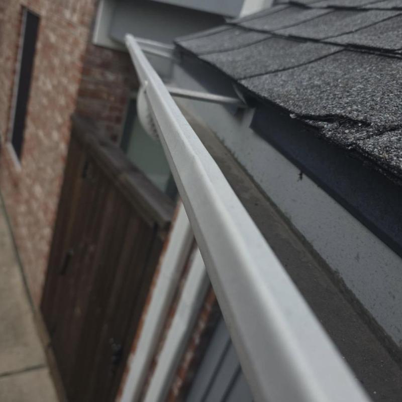 Gutter system inspection for hail damage on roof edge Gutter system inspection for hail damage on roof edge
