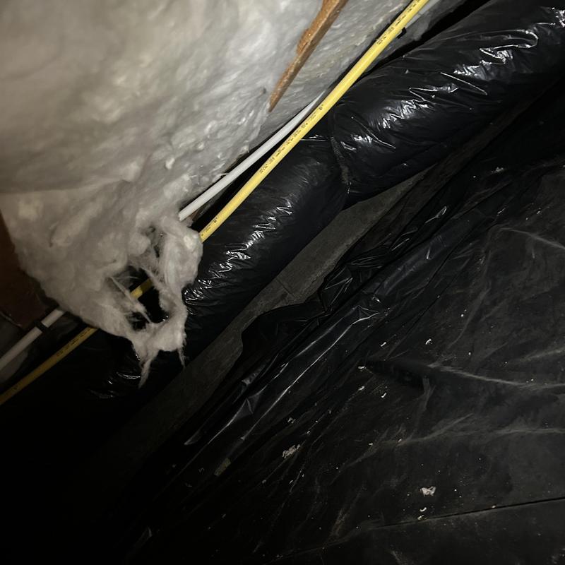 Crawl space plumbing and insulation inspection with piping