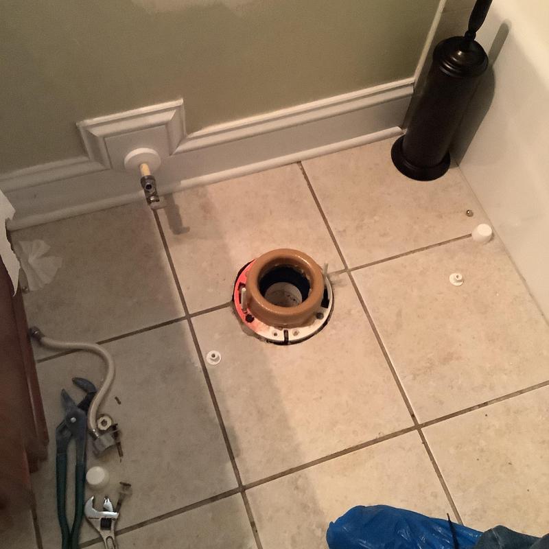 Toilet flange and wax ring replacement area on tiled floor Toilet flange and wax ring replacement area on tiled floor