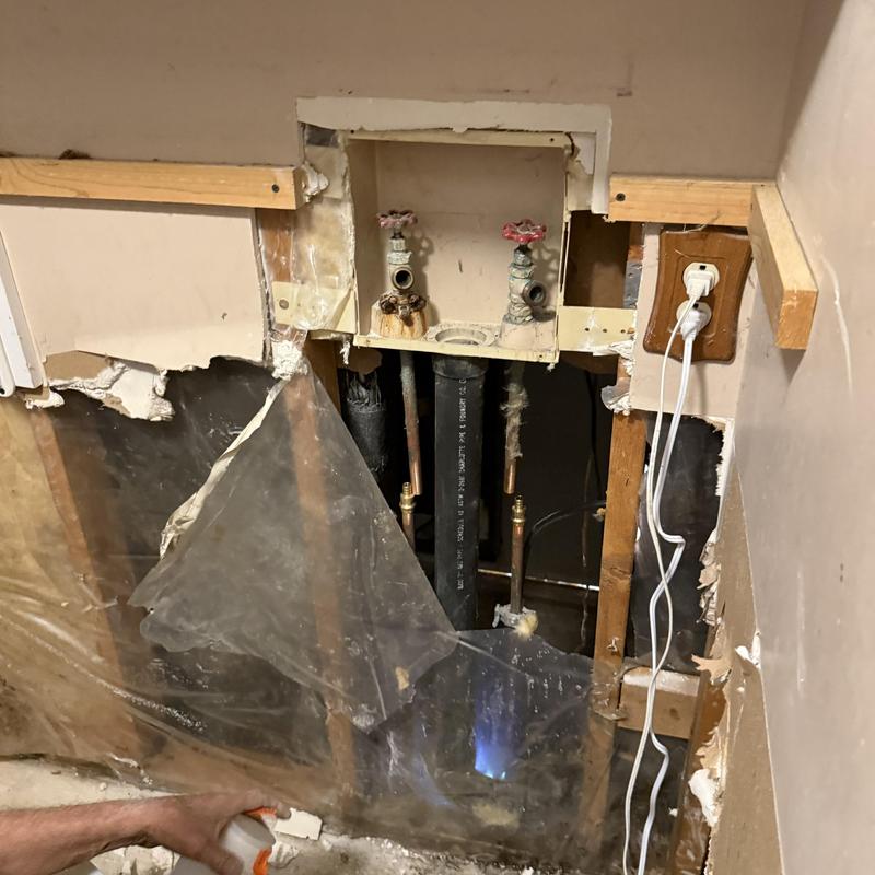 Washing machine valve box with exposed plumbing and drywall removal Washing machine valve box with exposed plumbing and drywall removal