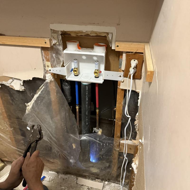 Washing machine box with water supply lines installation Washing machine box with water supply lines installation