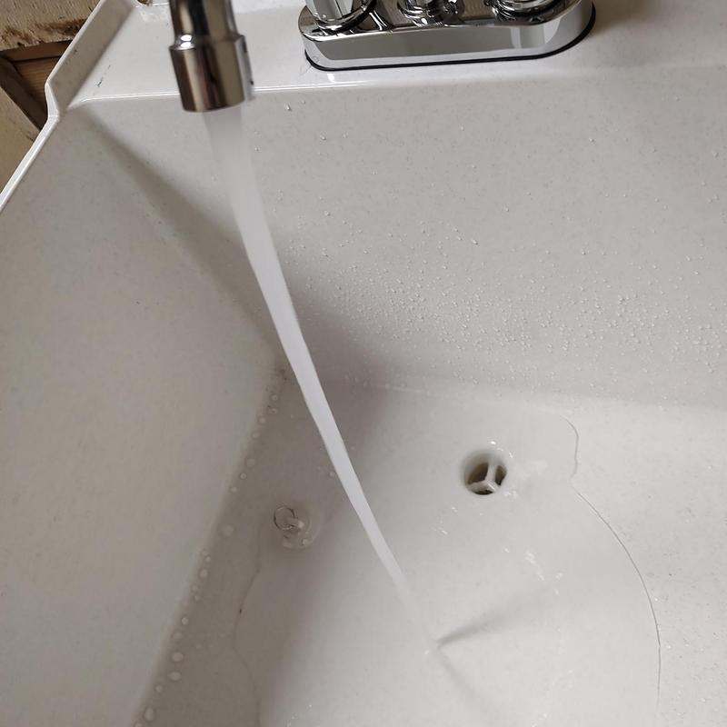 Mop sink with running faucet and drain opening Mop sink with running faucet and drain opening