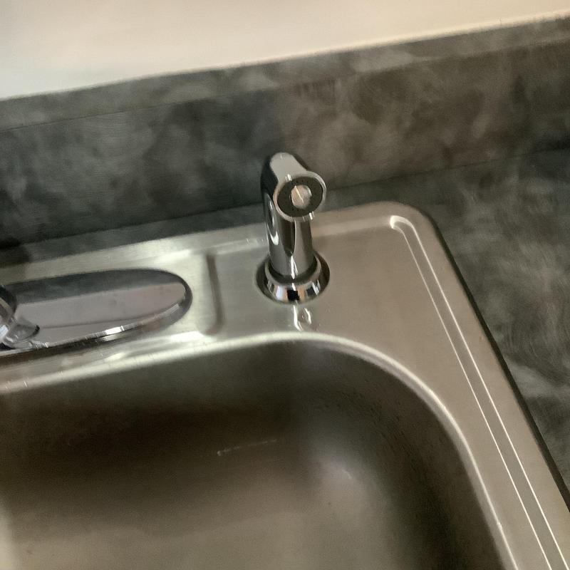 Delta kitchen sink sprayer installed on stainless sink Delta kitchen sink sprayer installed on stainless sink
