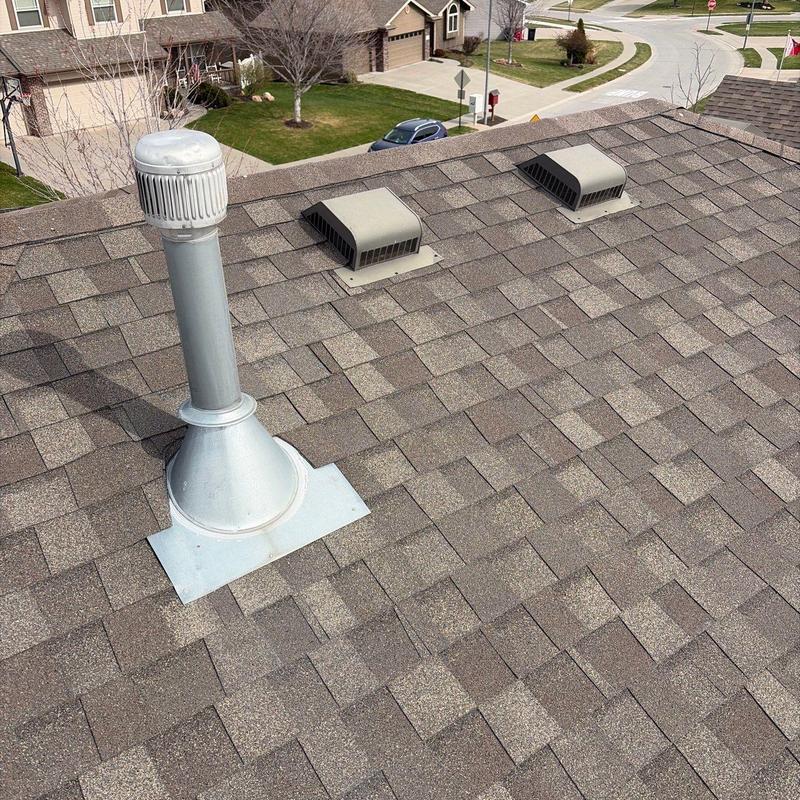 Asphalt shingle roof with vent pipe and roof vents