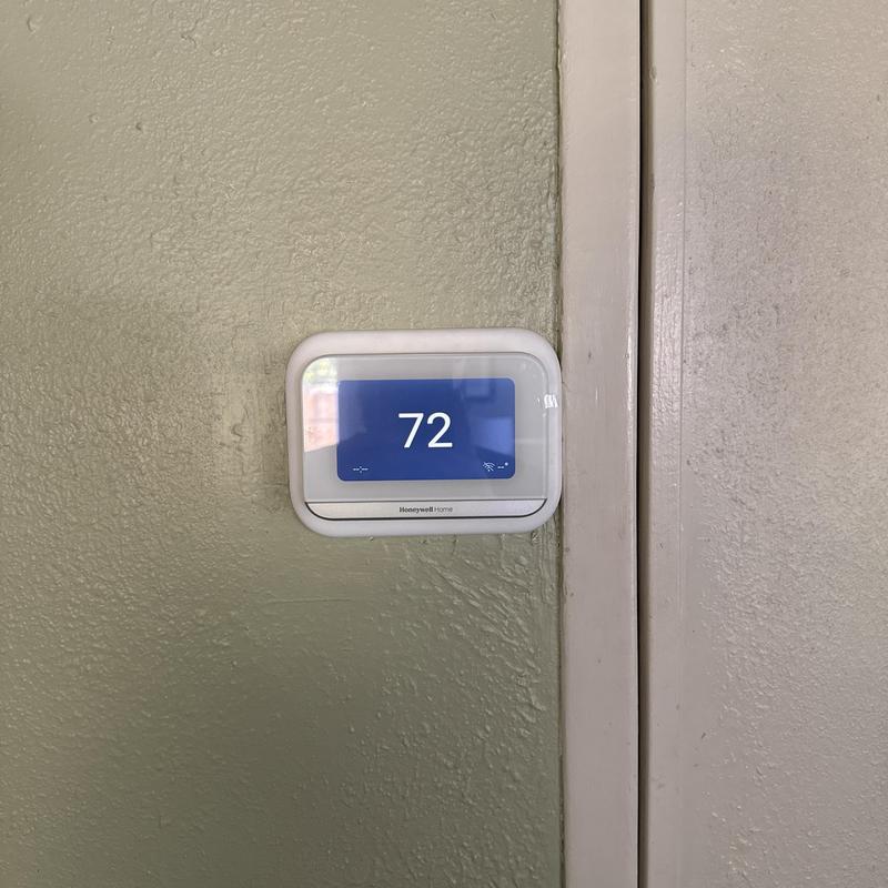Honeywell smart thermostat displaying 72°F on wall Honeywell smart thermostat displaying 72°F on wall