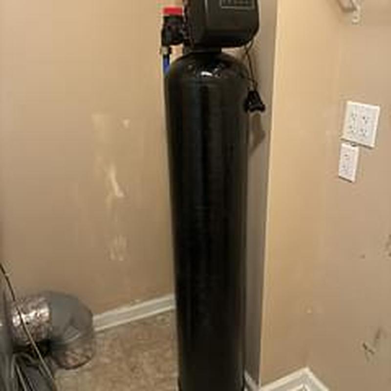 Water softener unit installation in utility room