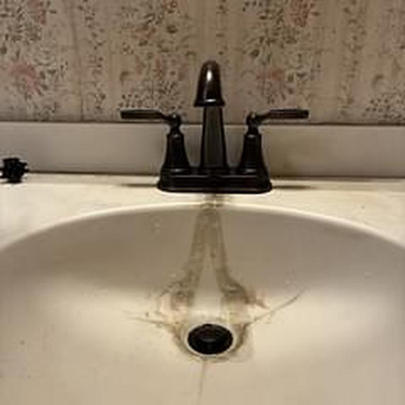 Lavatory faucet and sink with water stains