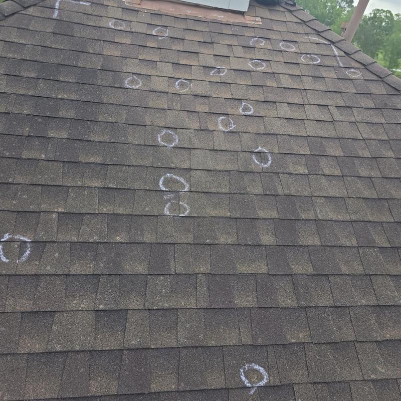 Architectural shingle roof with marked hail damage spots Architectural shingle roof with marked hail damage spots