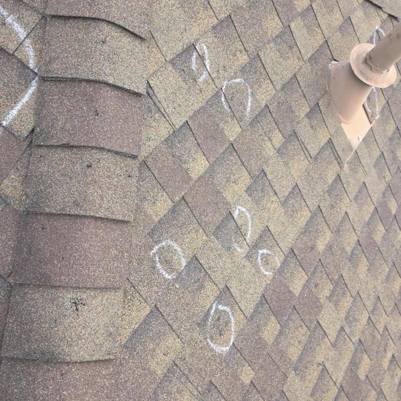 Architectural shingles with hail damage markings Architectural shingles with hail damage markings