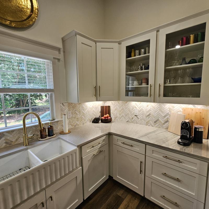 Farmhouse sink and brass faucet with marble countertop