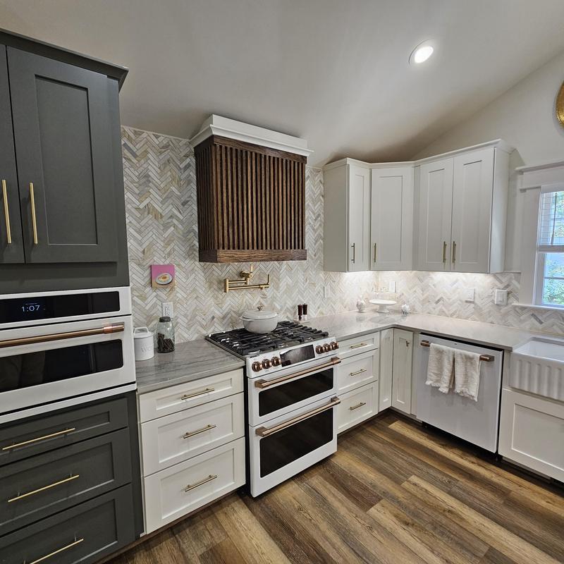 Gas range and white cabinetry in remodeled kitchen