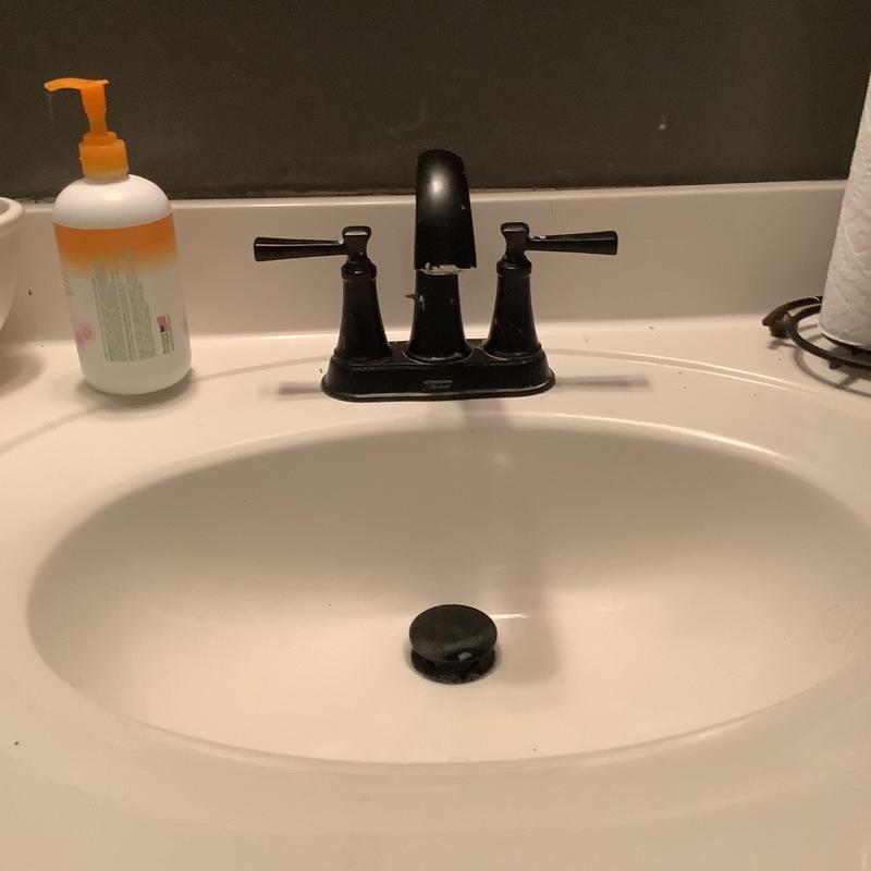 Delta vanity sink faucet on white countertop Delta vanity sink faucet on white countertop