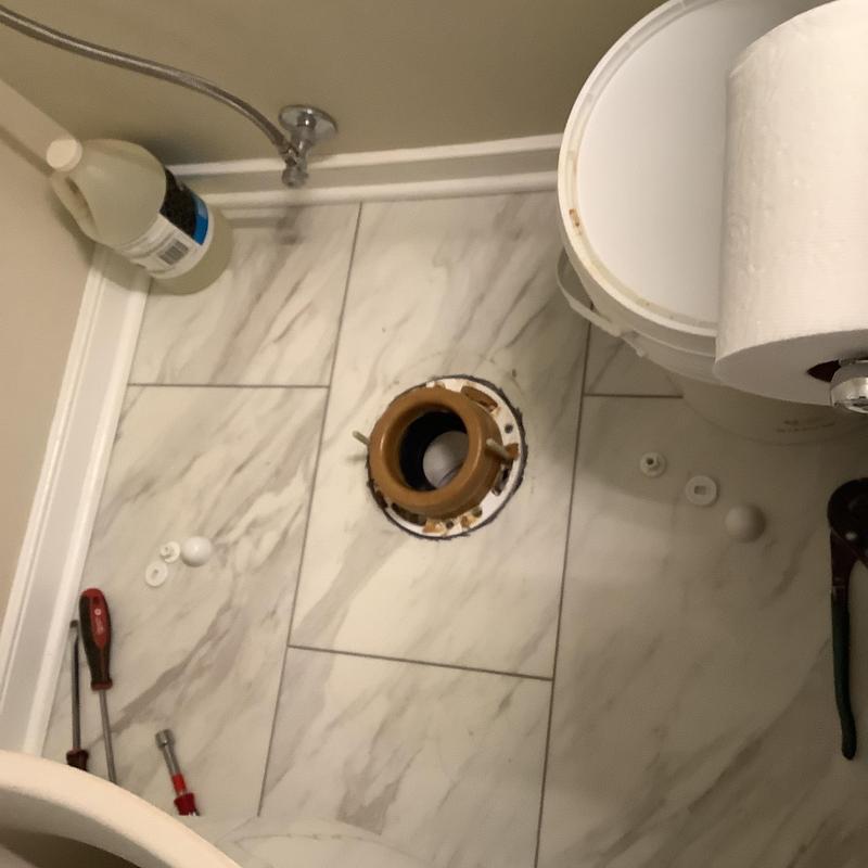 Toilet flange installation with tools on tiled floor Toilet flange installation with tools on tiled floor