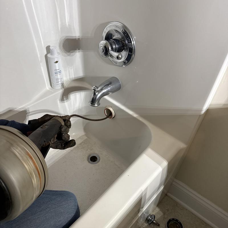 Tub drain snake clearing clog in kids bathroom tub Tub drain snake clearing clog in kids bathroom tub