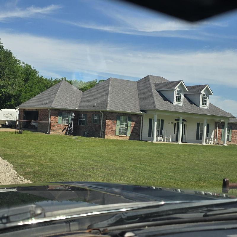 Asphalt shingle roof with hail damage on residential home