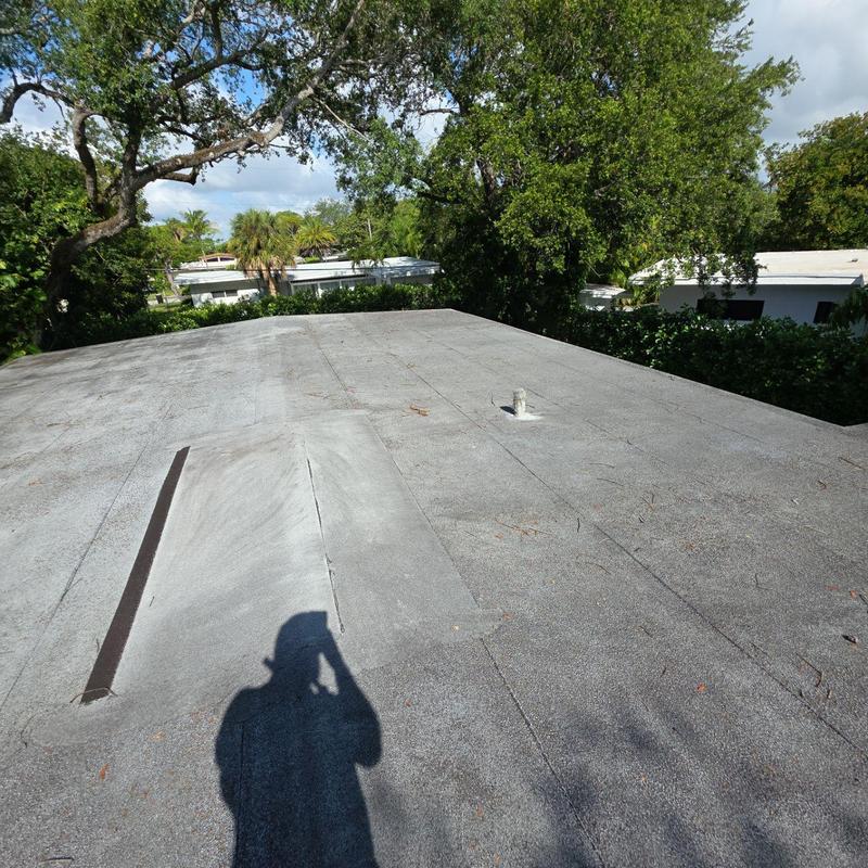 Flat roof surface with vent pipe and shadow