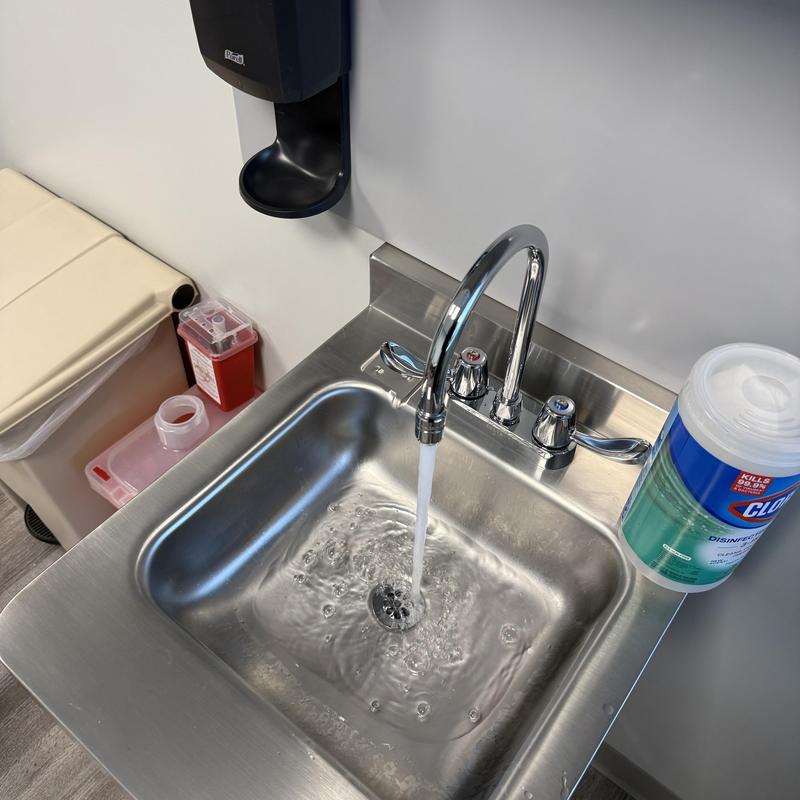 Kitchen sink chrome faucet with water running Kitchen sink chrome faucet with water running