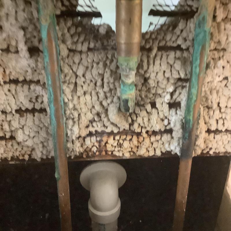 Tub drain pipe with corroded copper plumbing behind wall Tub drain pipe with corroded copper plumbing behind wall