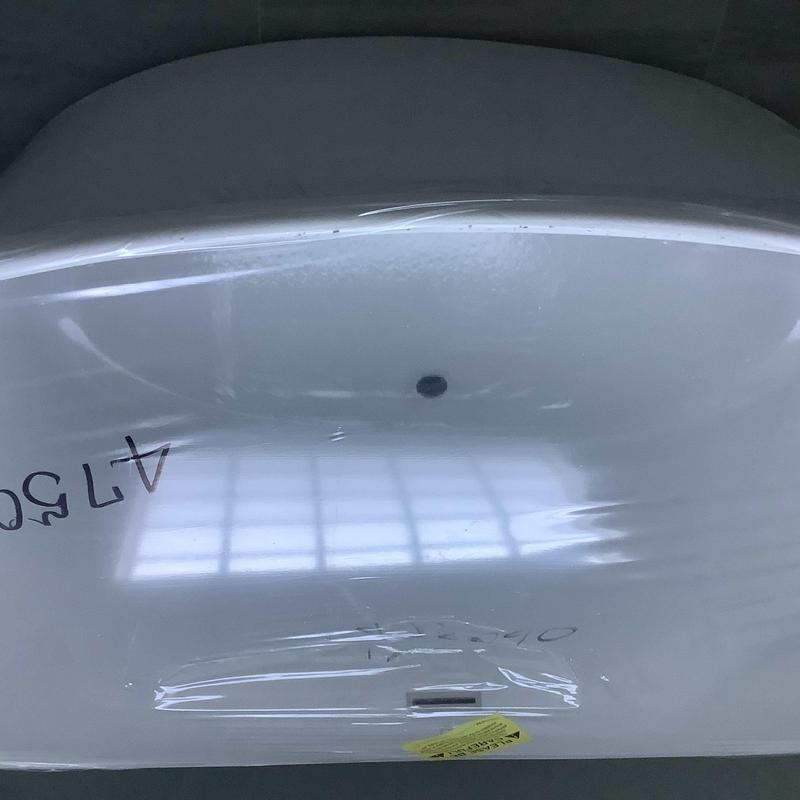 Freestanding bathtub with protective wrapping in installation Freestanding bathtub with protective wrapping in installation