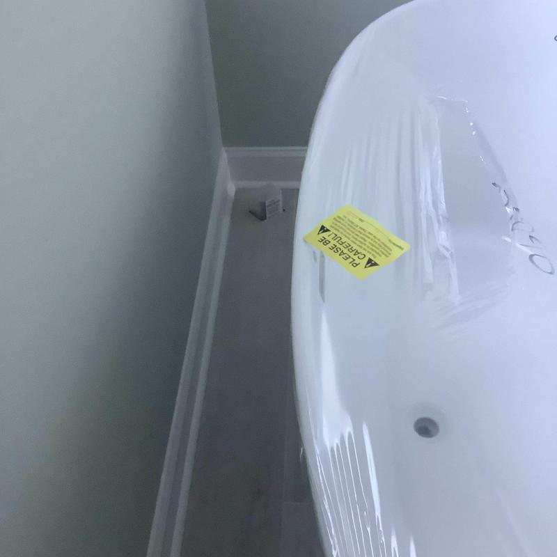 Freestanding bathtub with caution label during install Freestanding bathtub with caution label during install