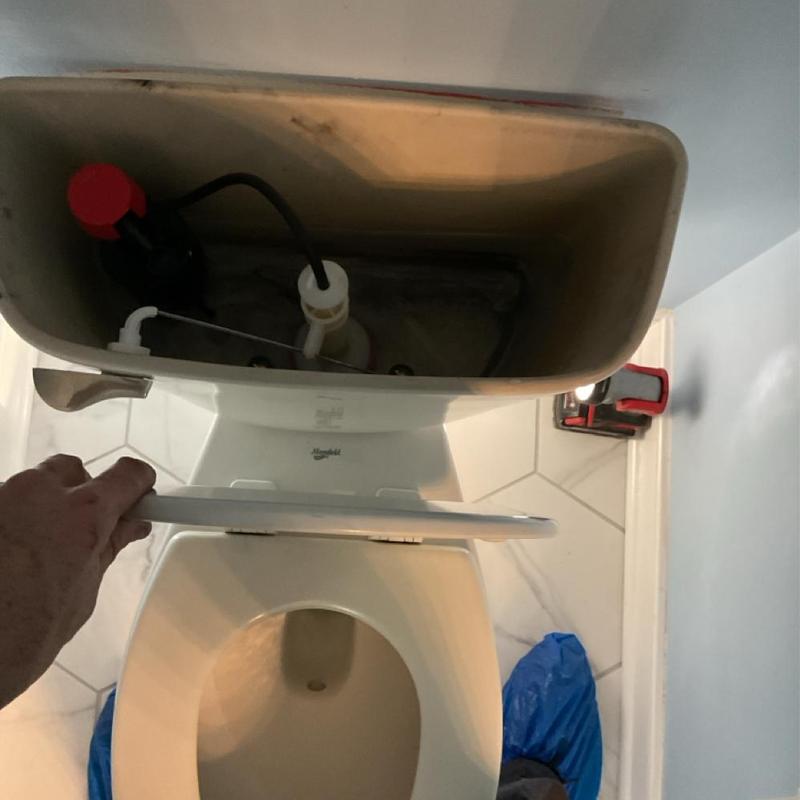 Toilet tank interior with rebuilt flush mechanism Toilet tank interior with rebuilt flush mechanism