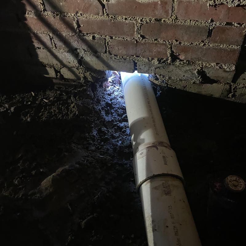 Sewer line PVC pipe installation through brick wall Sewer line PVC pipe installation through brick wall