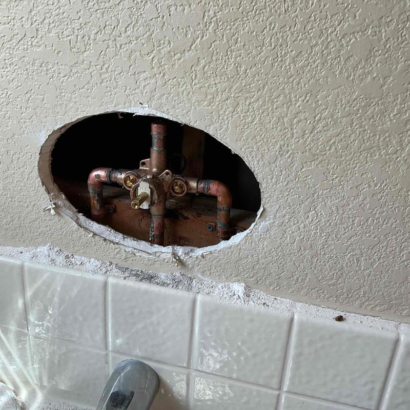 Moen valve and copper plumbing behind wall cutout