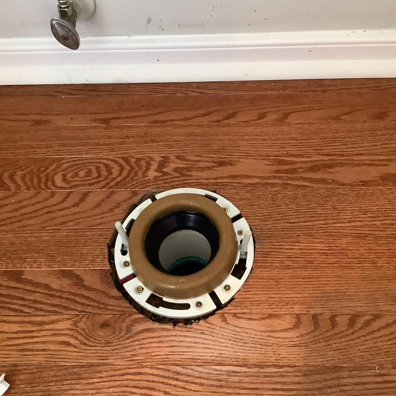 Toilet flange installed on hardwood floor Toilet flange installed on hardwood floor