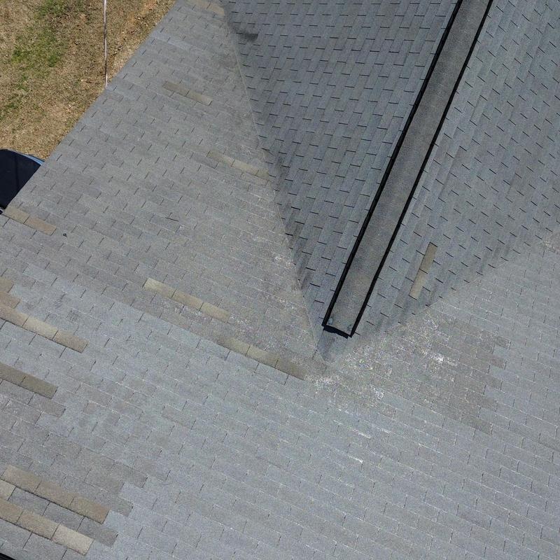 Asphalt shingle roof showing wear and discoloration Asphalt shingle roof showing wear and discoloration