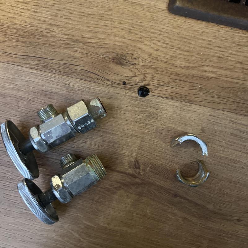 Kitchen sink shut off valves and seal parts on wood floor Kitchen sink shut off valves and seal parts on wood floor