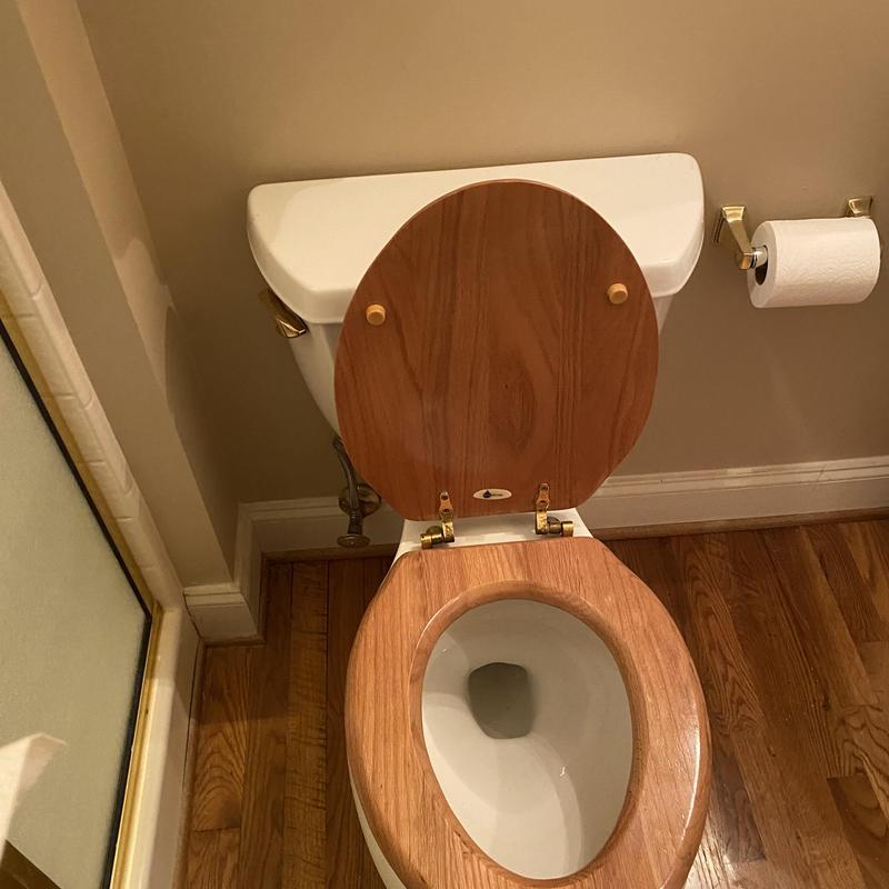 Toilet with wooden seat reset in Richmond bathroom Toilet with wooden seat reset in Richmond bathroom