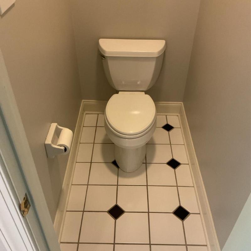 Toilet installation on tiled bathroom floor Toilet installation on tiled bathroom floor