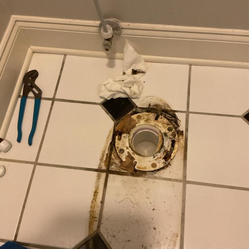 Toilet flange on tiled floor with plumbing tools Toilet flange on tiled floor with plumbing tools