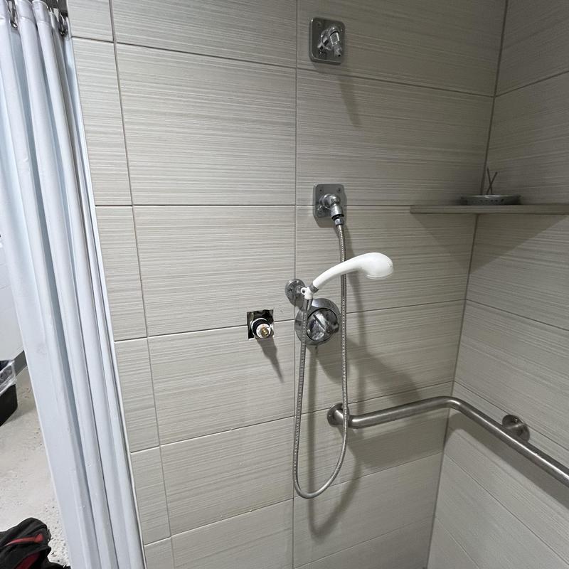 Shower valve cartridge removed for repair in locker room Shower valve cartridge removed for repair in locker room
