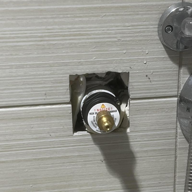 Shower valve cartridge exposed for repair in locker room Shower valve cartridge exposed for repair in locker room
