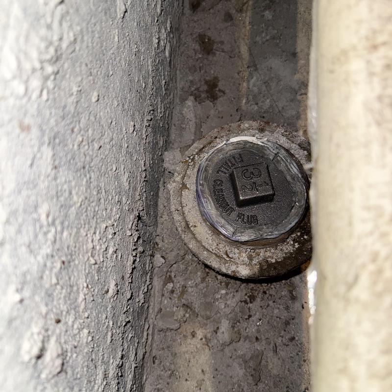 Main line cleanout plug recessed in concrete wall Main line cleanout plug recessed in concrete wall